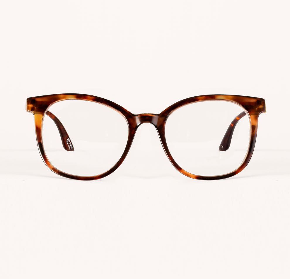 Tortoiseshell eyeglasses with large round lenses on a plain background.
